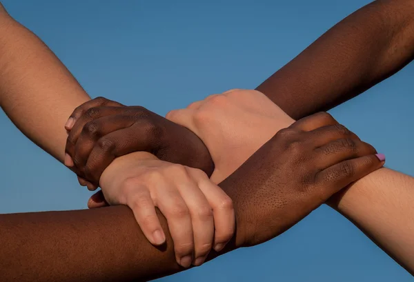 Joined hands of multiracial friends in cooperation as team — Stock Photo, Image