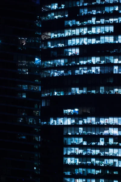 stock image Windows of business office in tall building, night