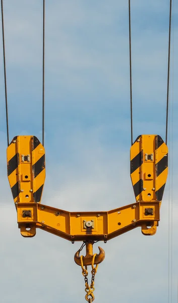 Bright orange tower crane against of blue sky , hook detail, construction concept — Stock Photo, Image
