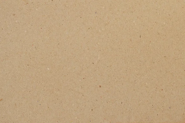 Cardboard, brown paper texture background close-up, surface with inclusions of cellulose — Stock Photo, Image