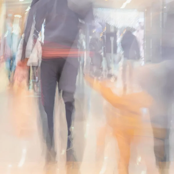 Unrecognizable Blurred People, families with children walking inside Shopping hall. Urban lifestyle. Abstract Background