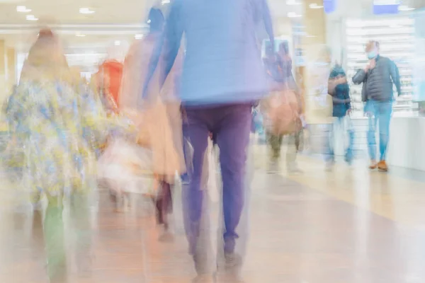 Unrecognizable blurred People, families with children walking in Shopping hall. Urban lifestyle, abstract Background