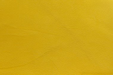 Buruşuk, buruşuk, moda sarısı, arka planlı hakiki deri.