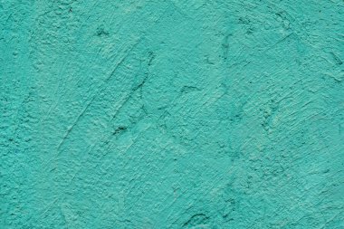 Sert Turkuaz alçı duvar dokusu kaba boyanmış yüzey, fırça darbeleri, ince düzensiz detaylar. Model, kopyalama alanı, arkaplan ve yaratıcı tasarım için kullanılan doku kavramı