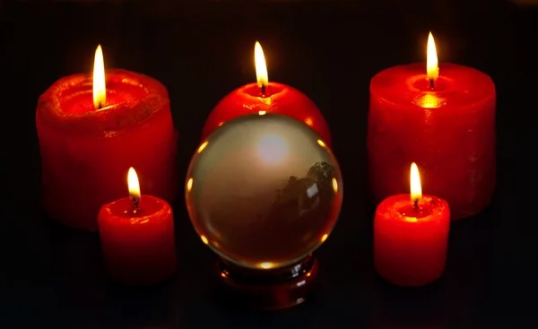 Crystal ball with candles — Stock Photo, Image