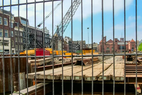 stock image Construction site in Amsterdam behind a metal lattice fence. Spring 2007