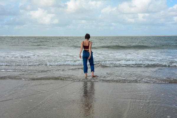Young Girl Jeans Short Top Playing Her Feet Water Sandy — Zdjęcie stockowe