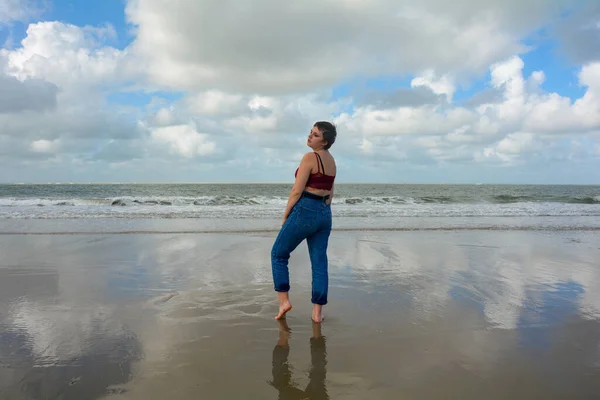 Young Girl Side Jeans Short Top Stands Barefoot Sandy Beach — Zdjęcie stockowe