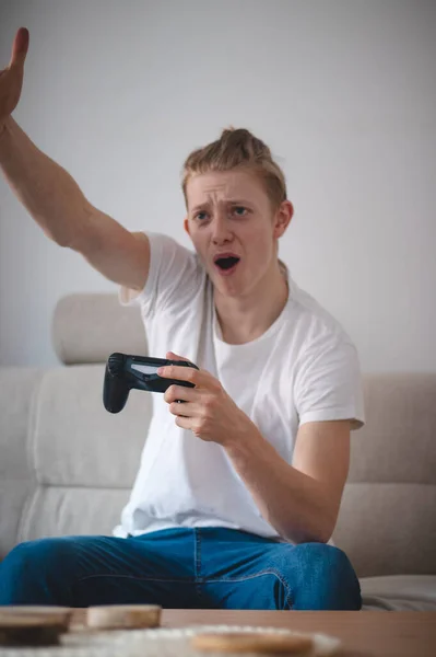 Angry Young Man Sitting Couch His Modern Living Room Throwing — Stock Photo, Image