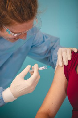 Koruyucu giysili bir bilim adamı şırıngaya aynı tür hastalığa karşı bir madde enjekte ediyor. Testlerde gönüllü ol. Tamamlayıcı tedavi. Yeni bir tedavi yöntemi. Genel salgın.