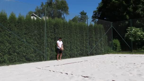 Young Volleyball Player White Shirt Black Shorts Shows Volleyball Serve — Stock Video