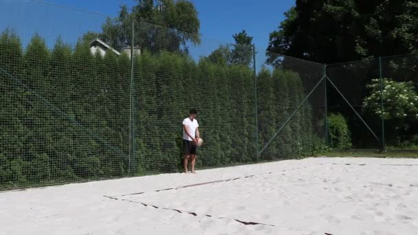 Young Volleyball Player White Shirt Black Shorts Shows Volleyball Serve — Stock Video