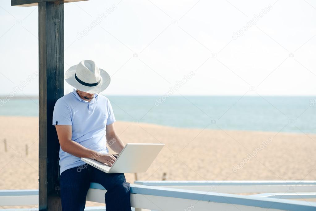 Businessman enjoying working outside with laptop computer 