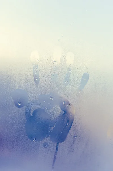 Отпечаток руки на мокром туманном окне с капельками воды. Фото крупным планом — стоковое фото