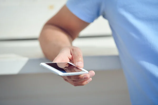 Man using mobile smart phone on white wall background — Stock Photo, Image