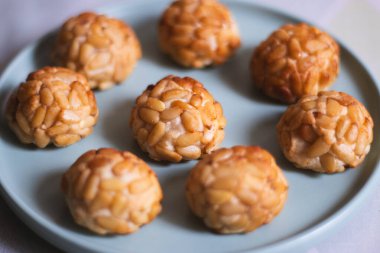 Close-up of traditional Catalan sweets called panellets made with marzipan and pine nuts. Typical dessert for All Saints Day in Spain. 