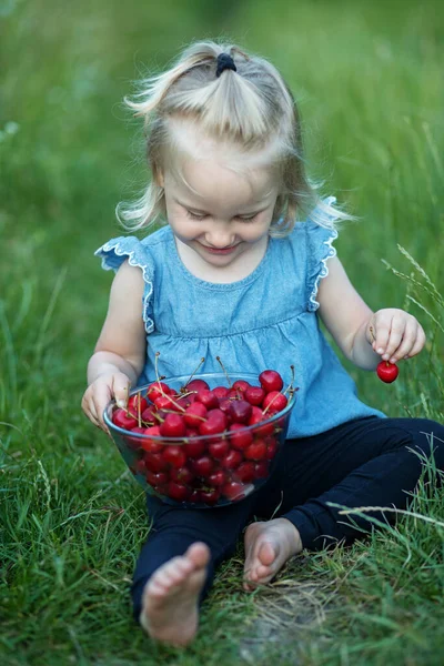 Kleines Mädchen Isst Kirschen Auf Naturhintergrund — Stockfoto