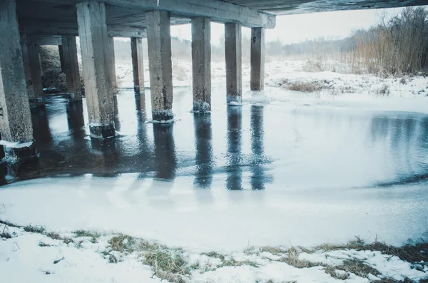 Ponte sobre um pequeno rio no inverno — Fotografia de Stock