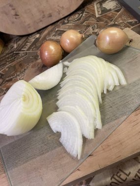 cut onion, onion and other ingredients for preparation on a table.