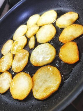 Çıtır çıtır patatesler, dilimler halinde dilimlenir, yağda kızartılır.