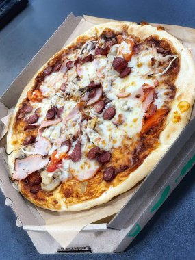 Mantarlı ızgara pizza, domates, salam, balyk ve erimiş peynir.