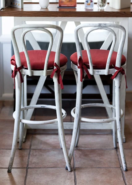 White vintage chairs with red pillow in cafe — Stock Photo, Image