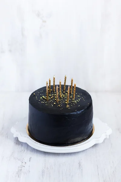 Birthday cake with golden candles — Stock Photo, Image
