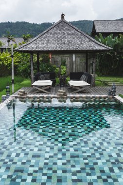 Havuzu şezlong şezlong ve şemsiyeler