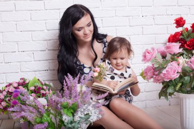 girl are reading a book in flowers