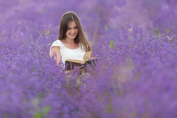 girl reading book in a lavender field