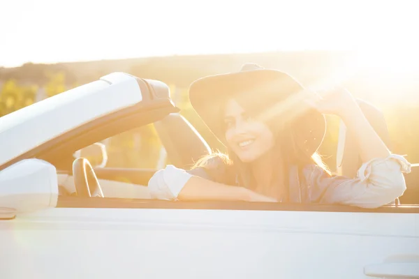 Cowboy girl sits in a cabriolet — Stock Photo, Image