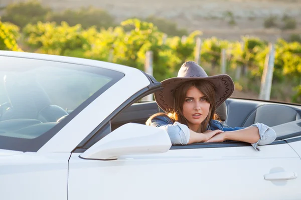 The girl sitting behind the wheel of a white convertible — Stock Photo, Image