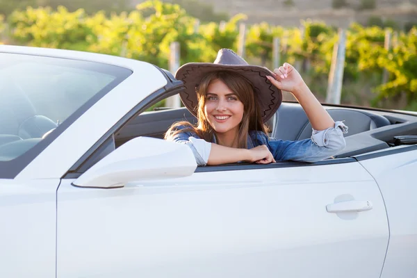 Cowboy girl driver in white convertible — Stock Photo, Image
