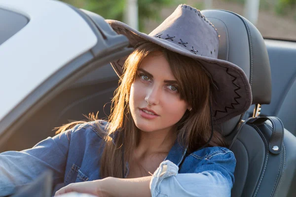 Cowboy girl driver in white convertible — Stock Photo, Image