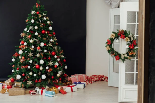 Árbol de Navidad decorado con juguetes con regalos en el interior de la habitación fondo negro año nuevo —  Fotos de Stock