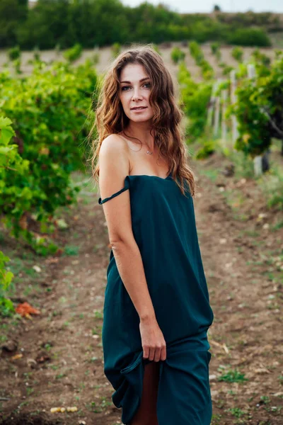 Bela mulher de vestido com um copo de vinho em um piquenique na vinha — Fotografia de Stock