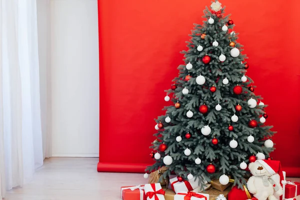 Decoración roja interior de la tarjeta de Año Nuevo y árbol de Navidad con regalos —  Fotos de Stock