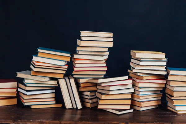 Stacks of books for education in the library on a black background place for inscription — Stock Photo, Image