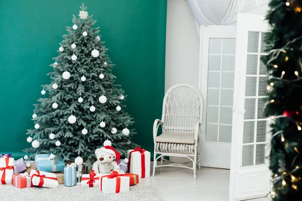 Árvore de Natal com presentes embaixo na sala de estar. Quarto branco. — Fotografia de Stock