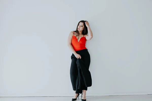 Beautiful fashionable oriental brunette woman in black orange dress — Stock Photo, Image