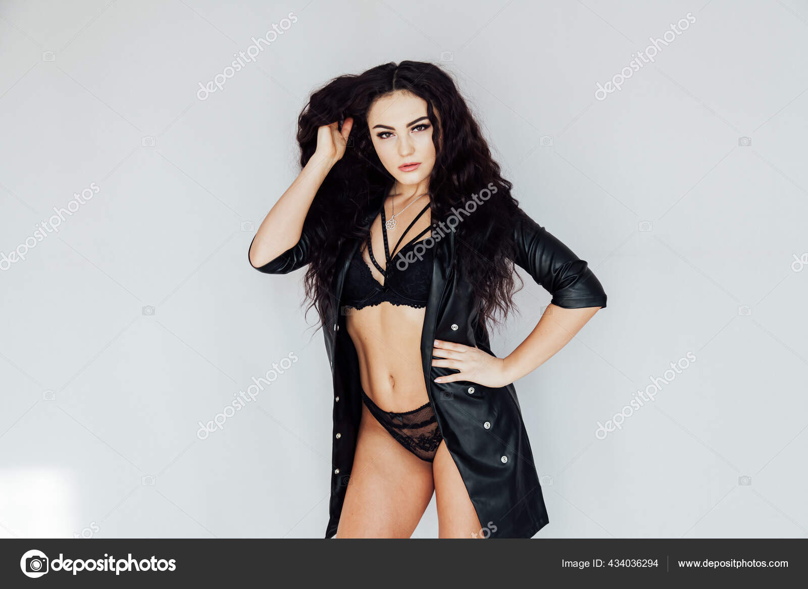 Portrait of a beautiful brunette woman in black lingerie posing
