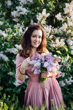 Leylak çiçekli, güzel esmer bir kadının portresi.