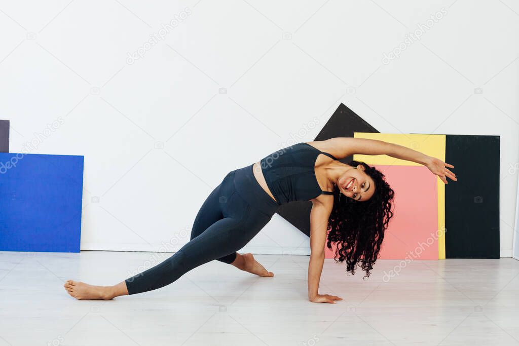 beautiful woman brunette does yoga gymnastics asana one