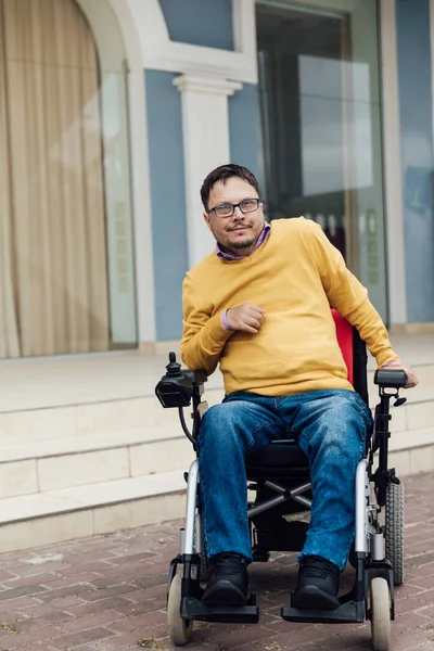 a man with disabilities in a wheelchair enjoys life