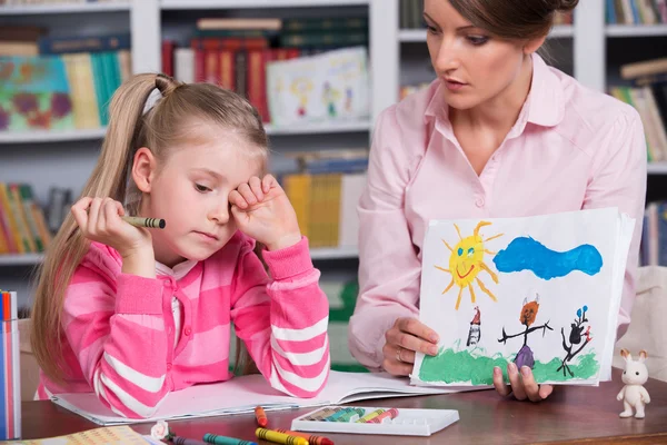 Детский психолог обсуждает рисунок маленькой девочки — стоковое фото