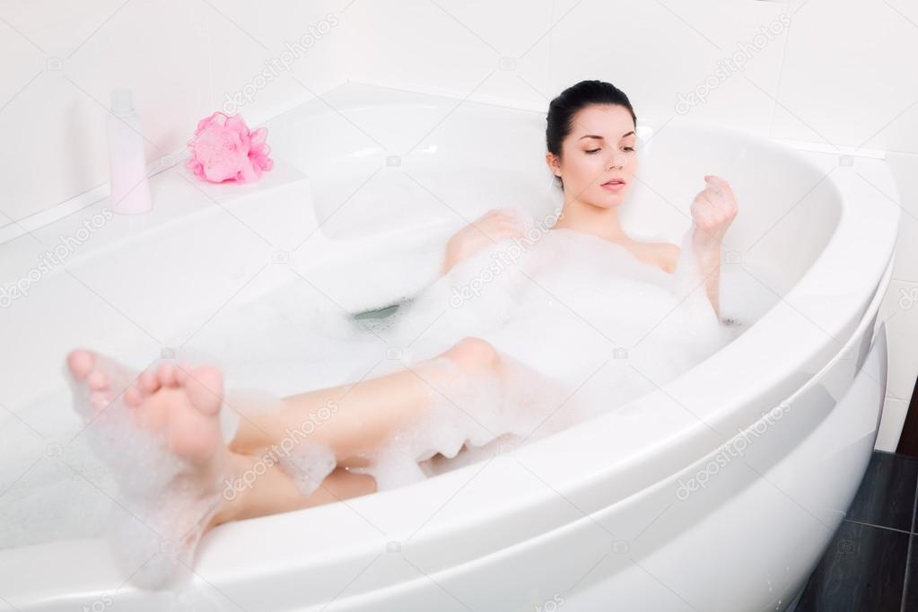 beautiful young woman takes bubble bath