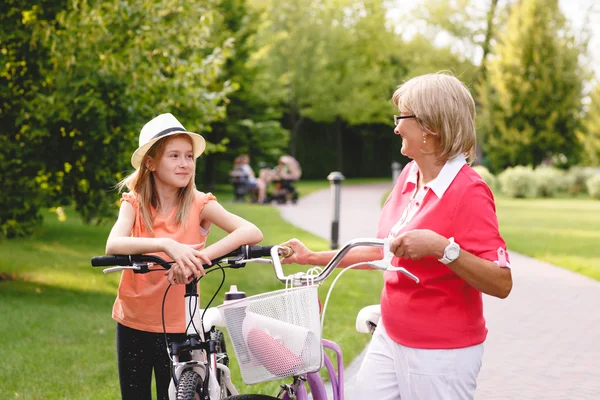 Active senior woman riding bike in a park