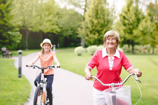 Active senior woman riding bike in a park