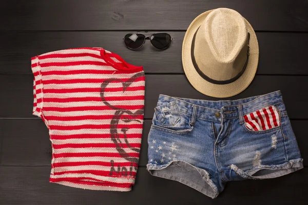 Ahşap bir arka planda hippi kıyafetleri ve aksesuarlar.