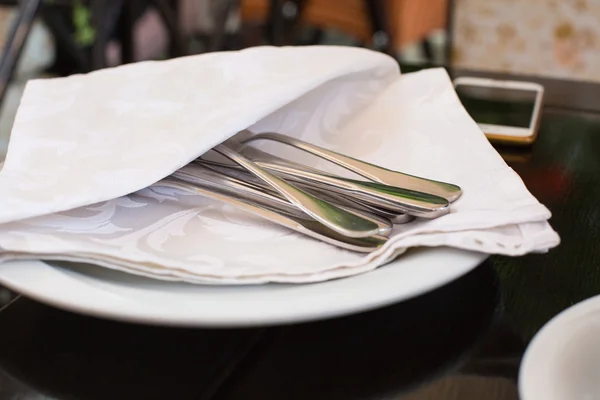 High Angle View of Silver Knife and Fork Tied with String and Blank Tag on White Napkin with Fringed Edges on Rustic Wooden Table with Copy Space — Stock Photo, Image